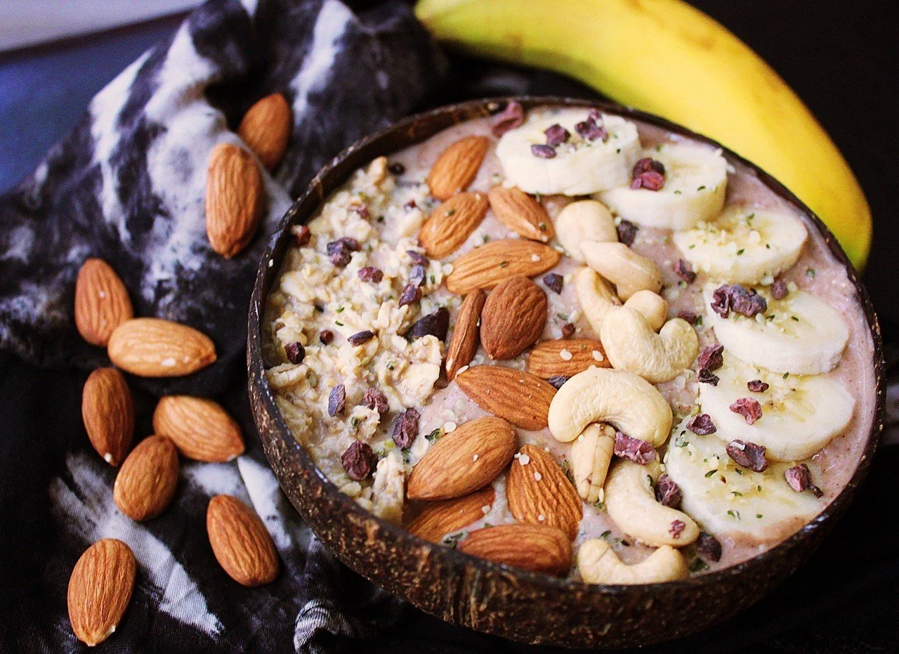 A nourishing smoothie bowl with nuts, banana and cacao