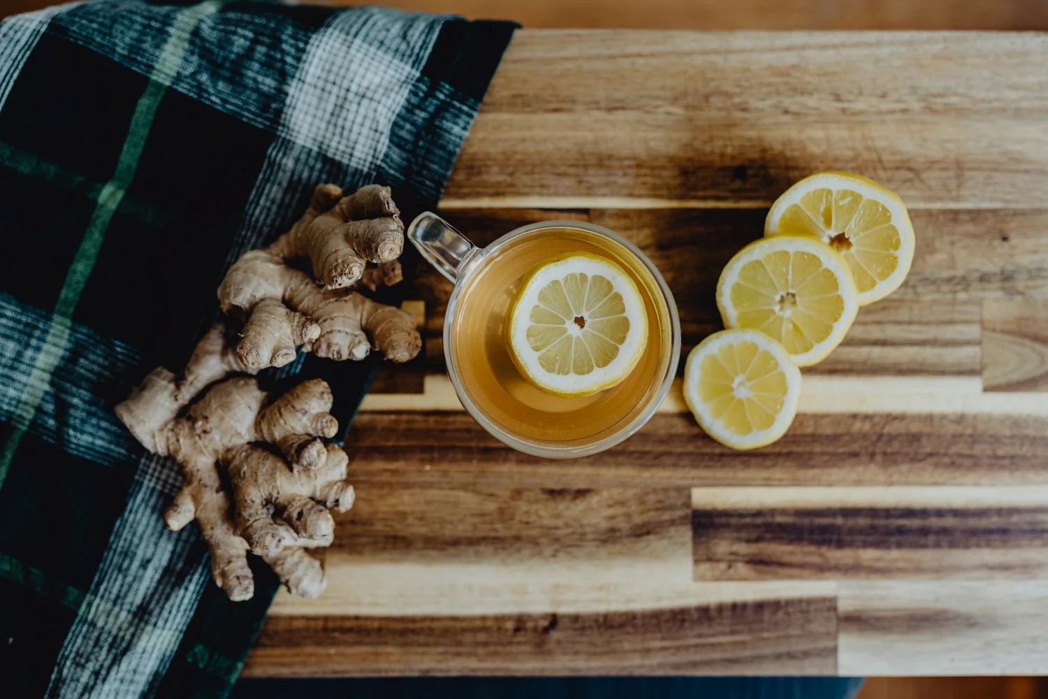 Ginger and lemon detox tea on a wooden board — food as medicine
